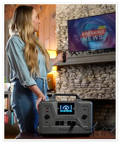Woman using Patriot Power Generator to power TV
