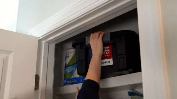Sliding a 2-Week Kit tote onto a pantry shelf