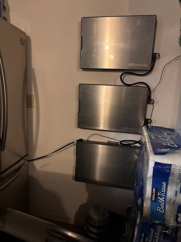 Real customer John H. with 3 Blackout Buddy units wall-mounted next to his fridge — pass-through ready