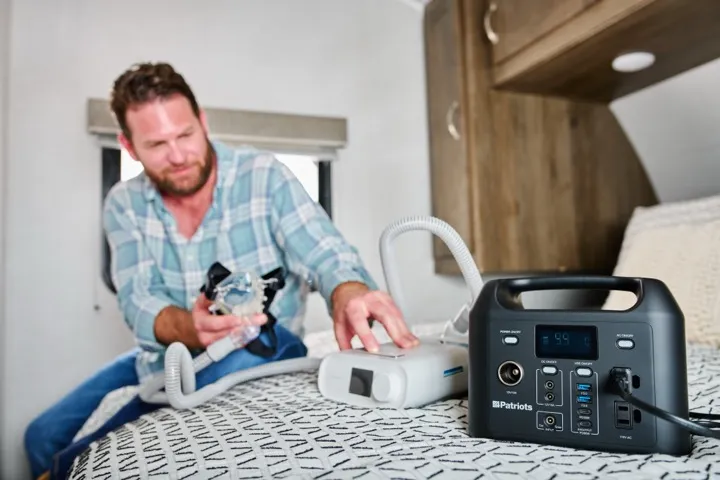 Patriot Power Sidekick on a nightstand powering bedside devices in an RV