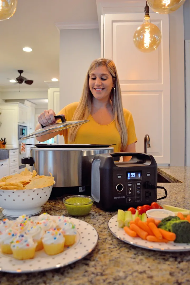 Woman in kitchen using the Patriot Power Sidekick near countertop appliances