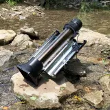 Sun Kettle set up outdoors beside a stream